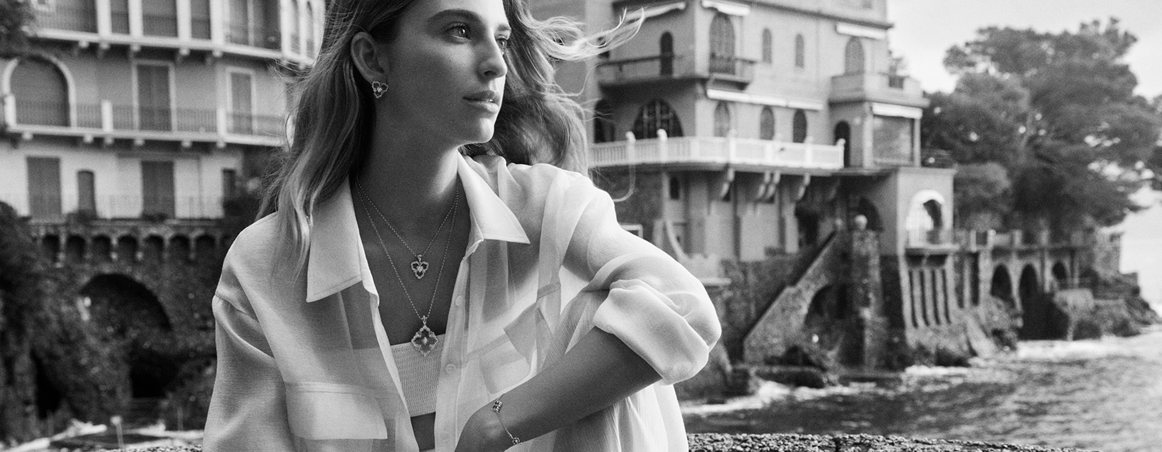 Model in black and white wearing Buccellati rings, necklaces and bracelets 